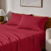 A bed made with matching flannel sheets and pillowcases
