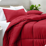 A side view of a modern bed with a comforter set and pillows on the bed