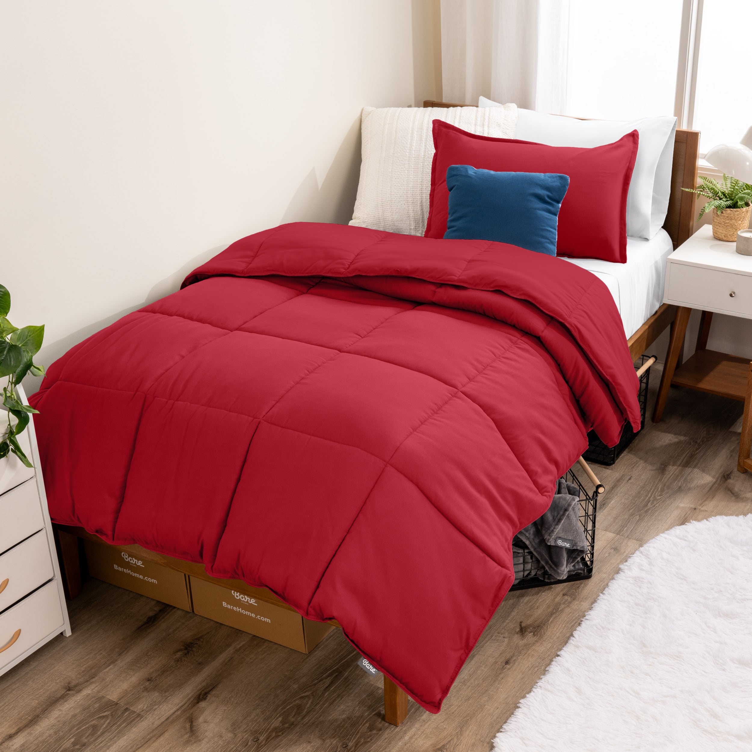 A modern bed with a down alternative comforter set on it