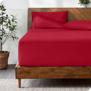 A modern bed with a fitted microfiber sheet made on the mattress.