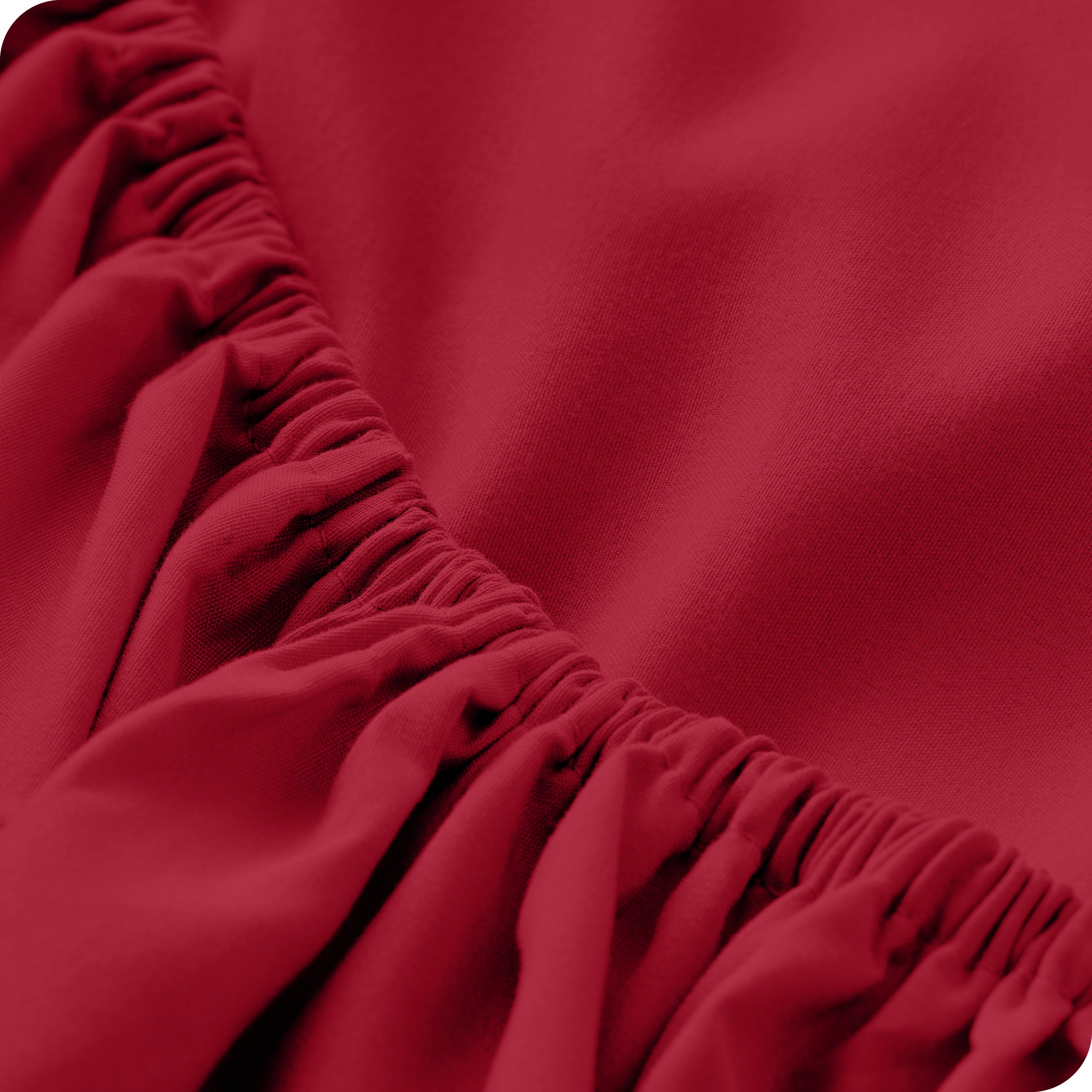 A close up of the elastic of a microfiber fitted sheet.