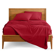 Microfiber sheet set on a bed with a wooden bed frame