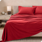 View of fleece sheets from the end of a bed with the top sheet draped over the side and end