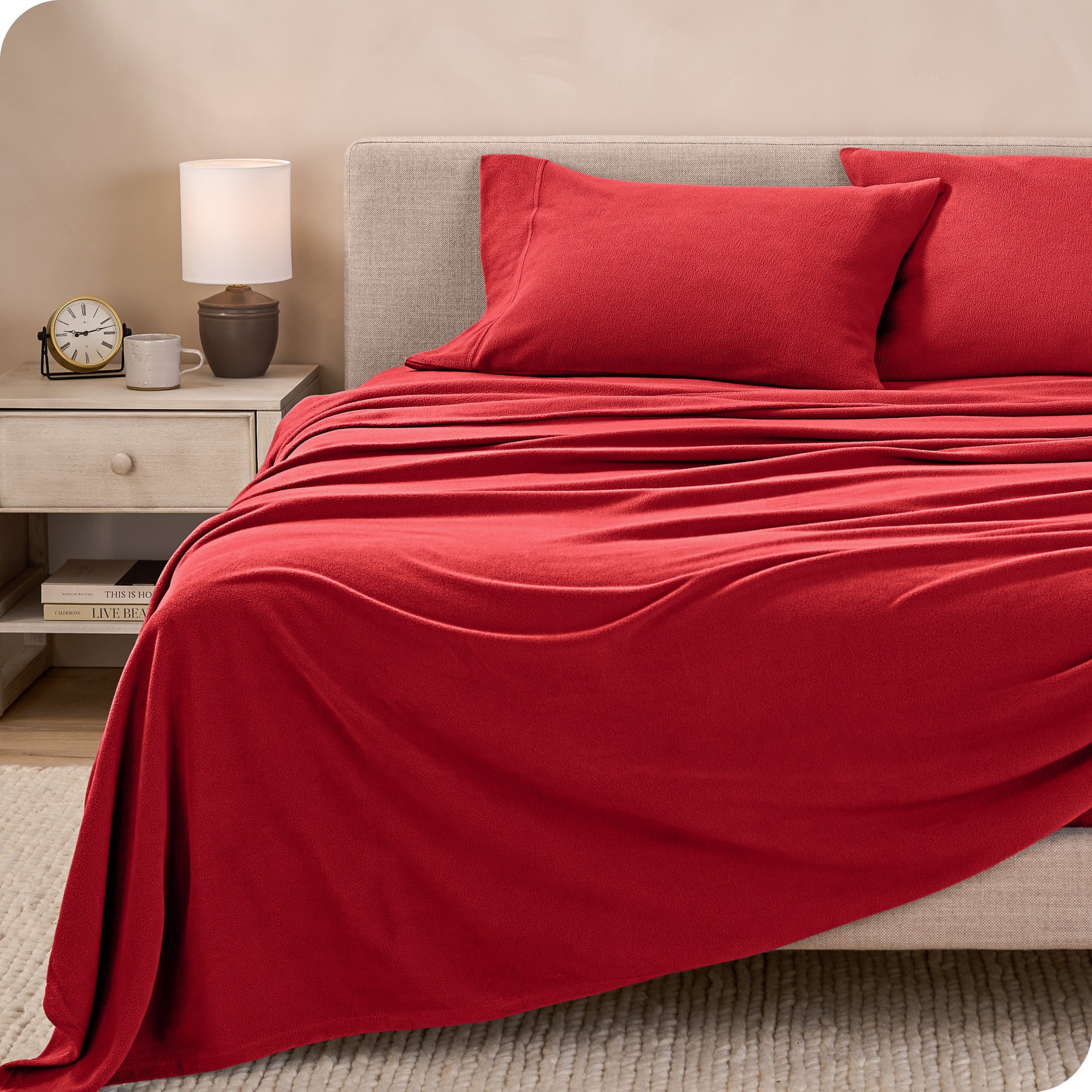 View of fleece sheets from the end of a bed with the top sheet draped over the side and end