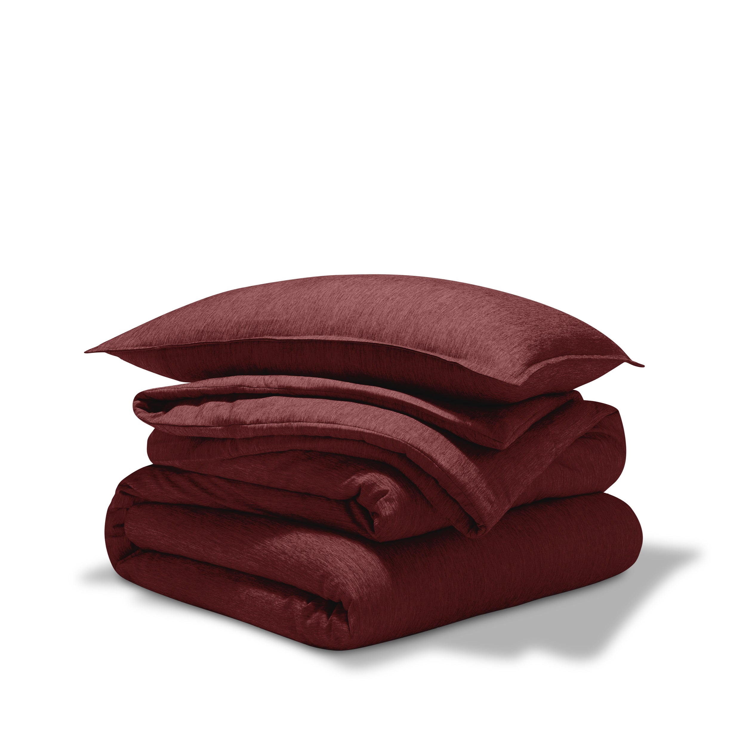 A comforter folded with a matching pillow sham stacked on top