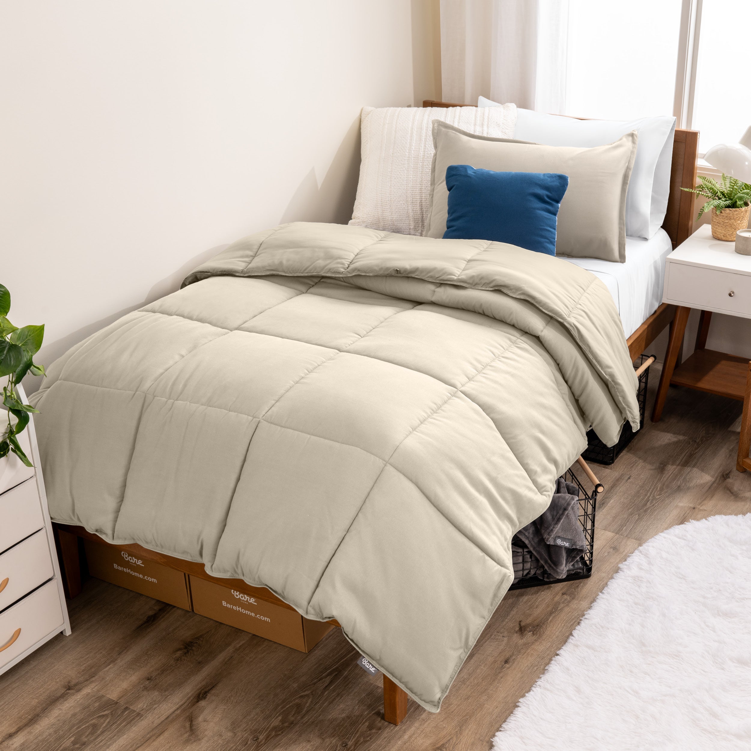 A modern bed with a down alternative comforter set on it