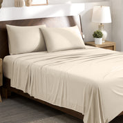 Stretch sheets on a bed with a wooden headboard in a bedroom setting.