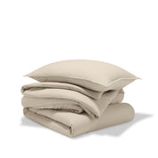 A comforter folded with a matching pillow sham stacked on top