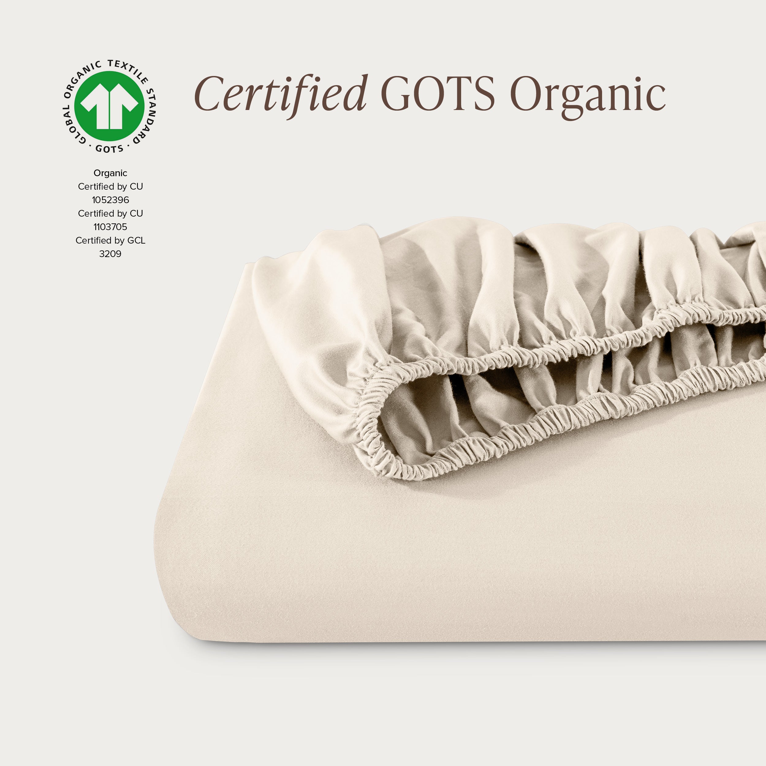 A single fitted sheet folded neatly showing part of the elastic. The fitted sheet is Certified GOTS Organic.