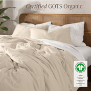 A bed made with an GOTs certified organic jersey duvet cover, pillow sham covered pillows and extra pillows