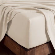 A corner of bed with fitted sheet to show the deep pocket feature and the texture.