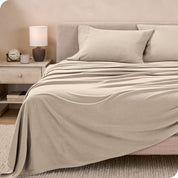 View of fleece sheets from the end of a bed with the top sheet draped over the side and end