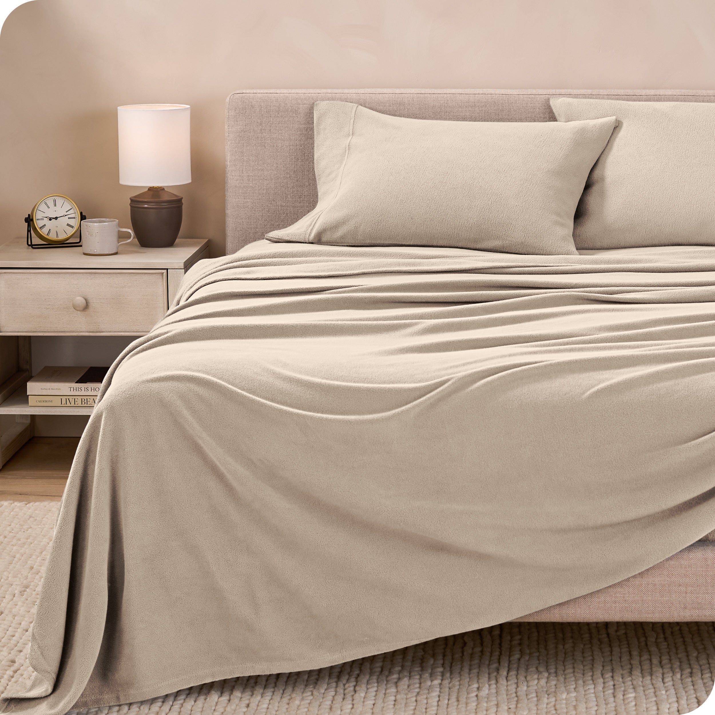 View of fleece sheets from the end of a bed with the top sheet draped over the side and end