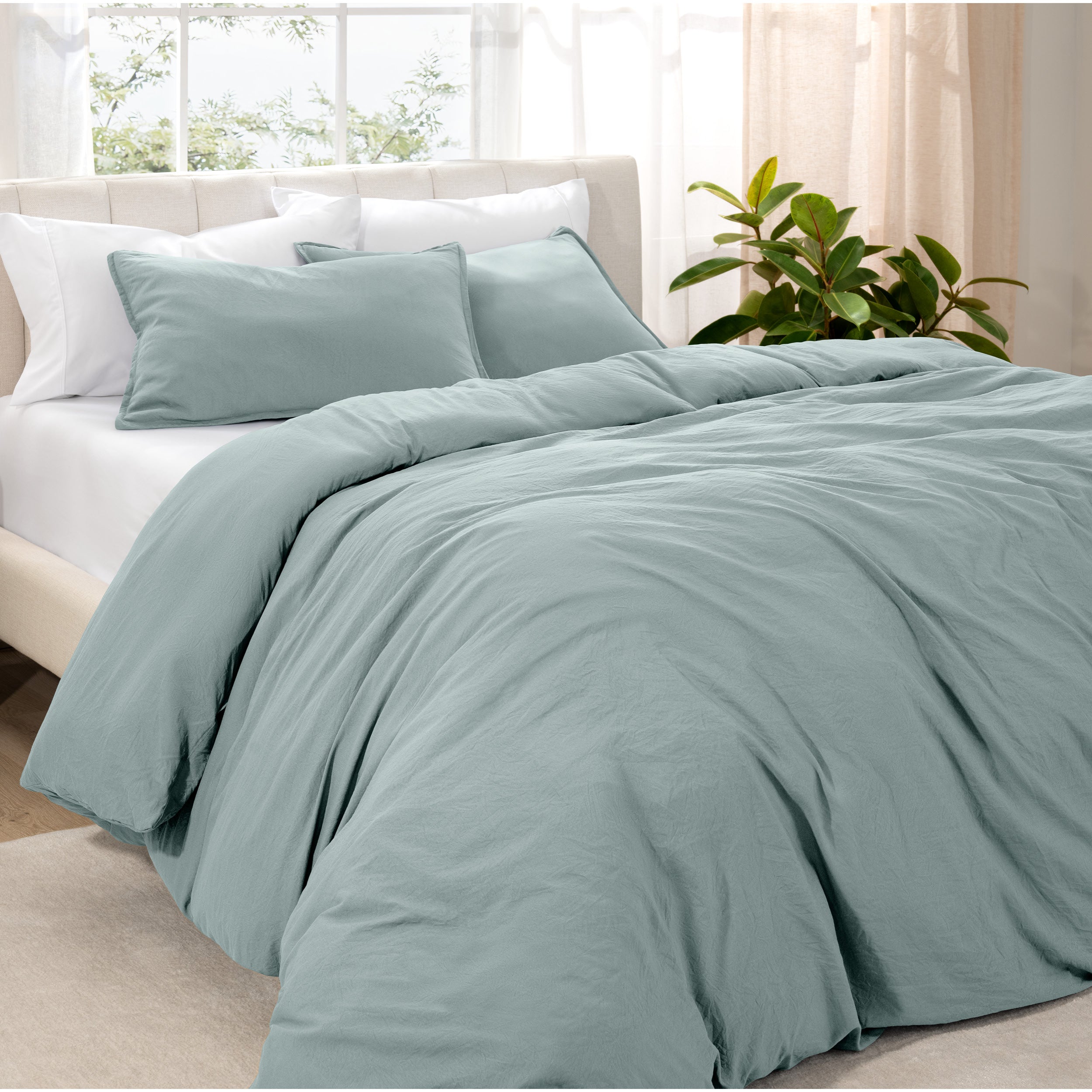 Angled view of bed with a duvet cover folded over on itself