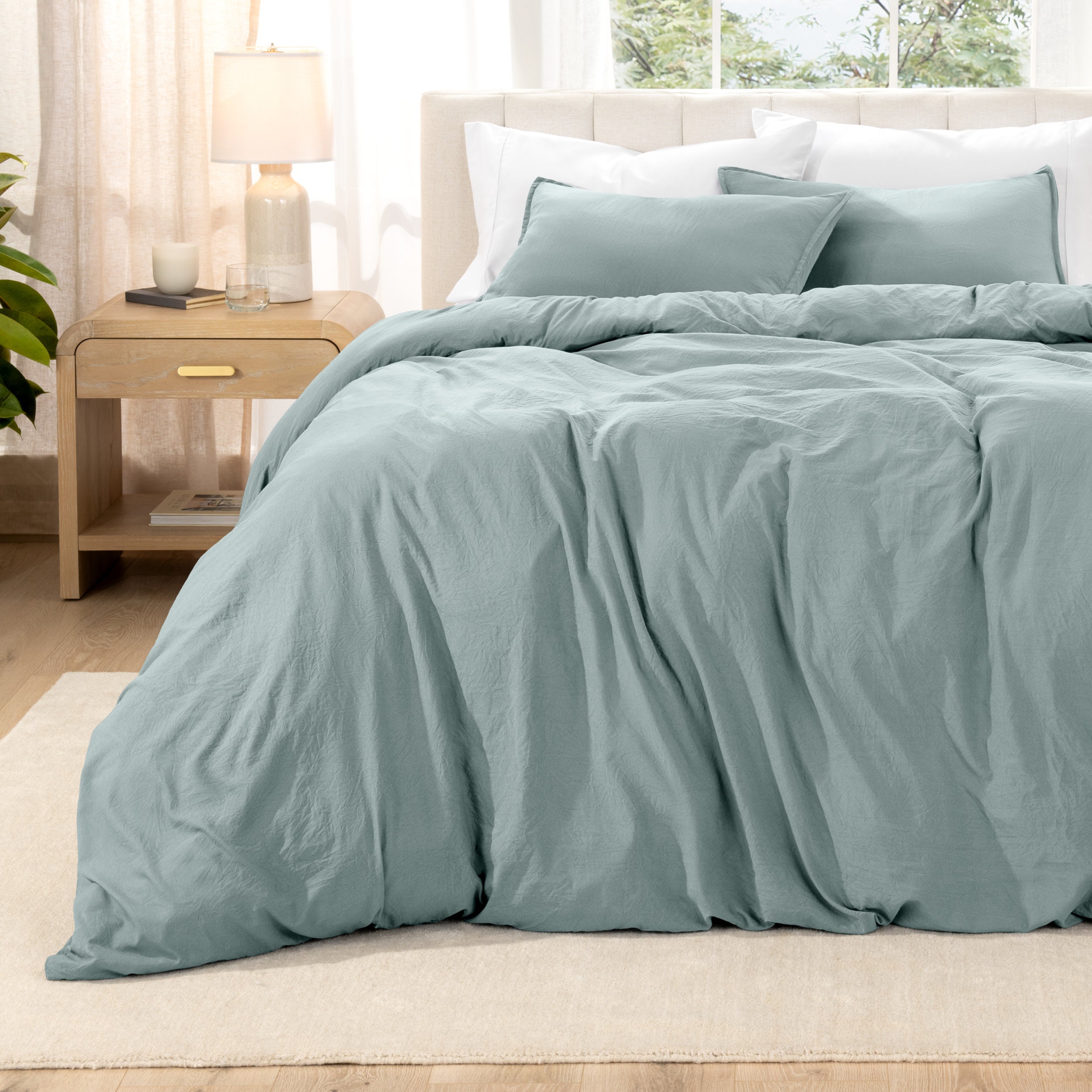 Relaxing room scene with a duvet cover laid out over the bed