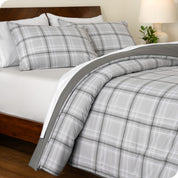 A side view of a bed made with a track stitch comforter set