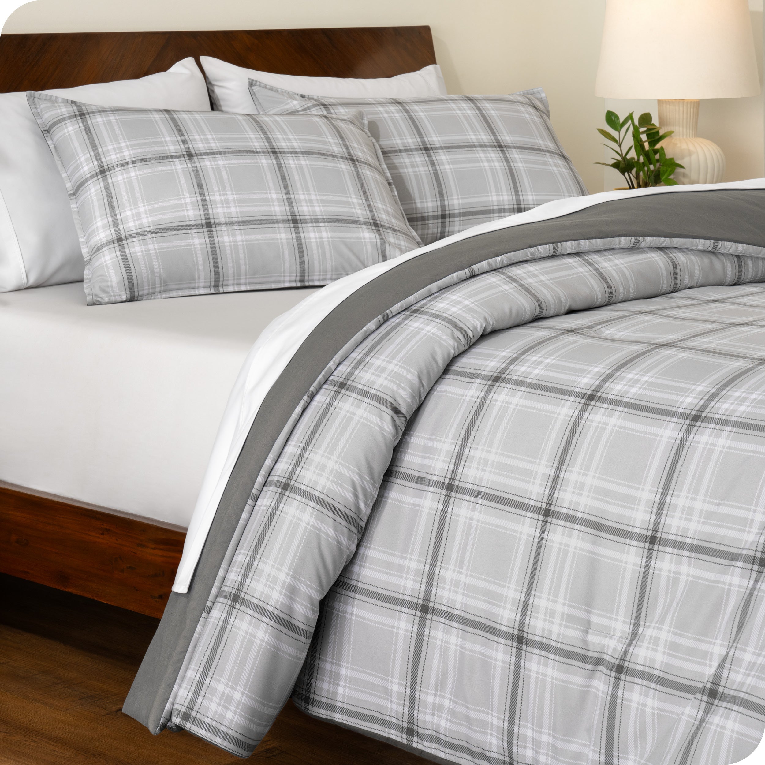 A side view of a bed made with a track stitch comforter set