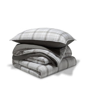 A comforter folded with a matching pillow sham stacked on top