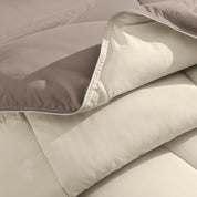 Close up of the reversible comforter showing the box stitching and the two colors
