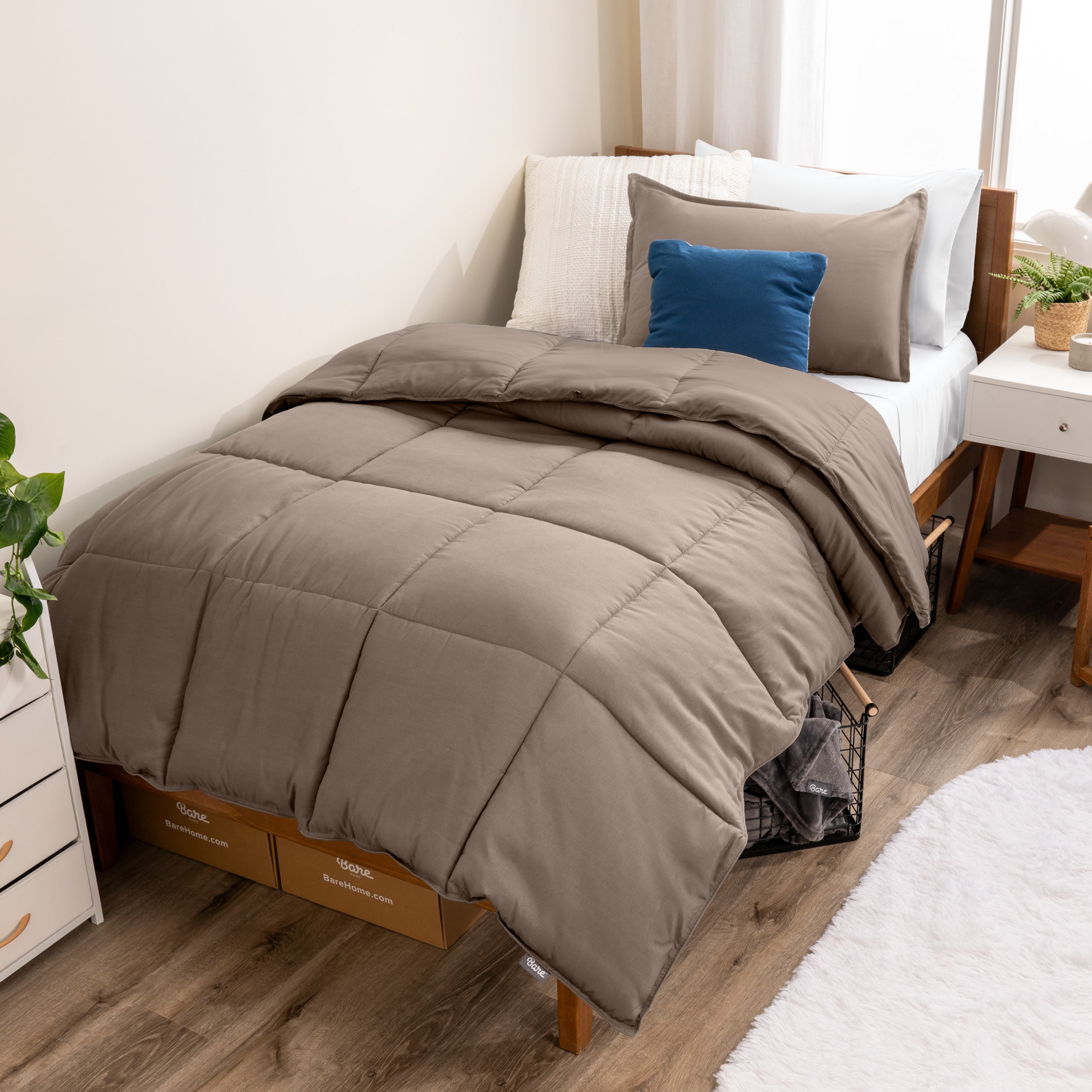 A modern bed with a down alternative comforter set on it