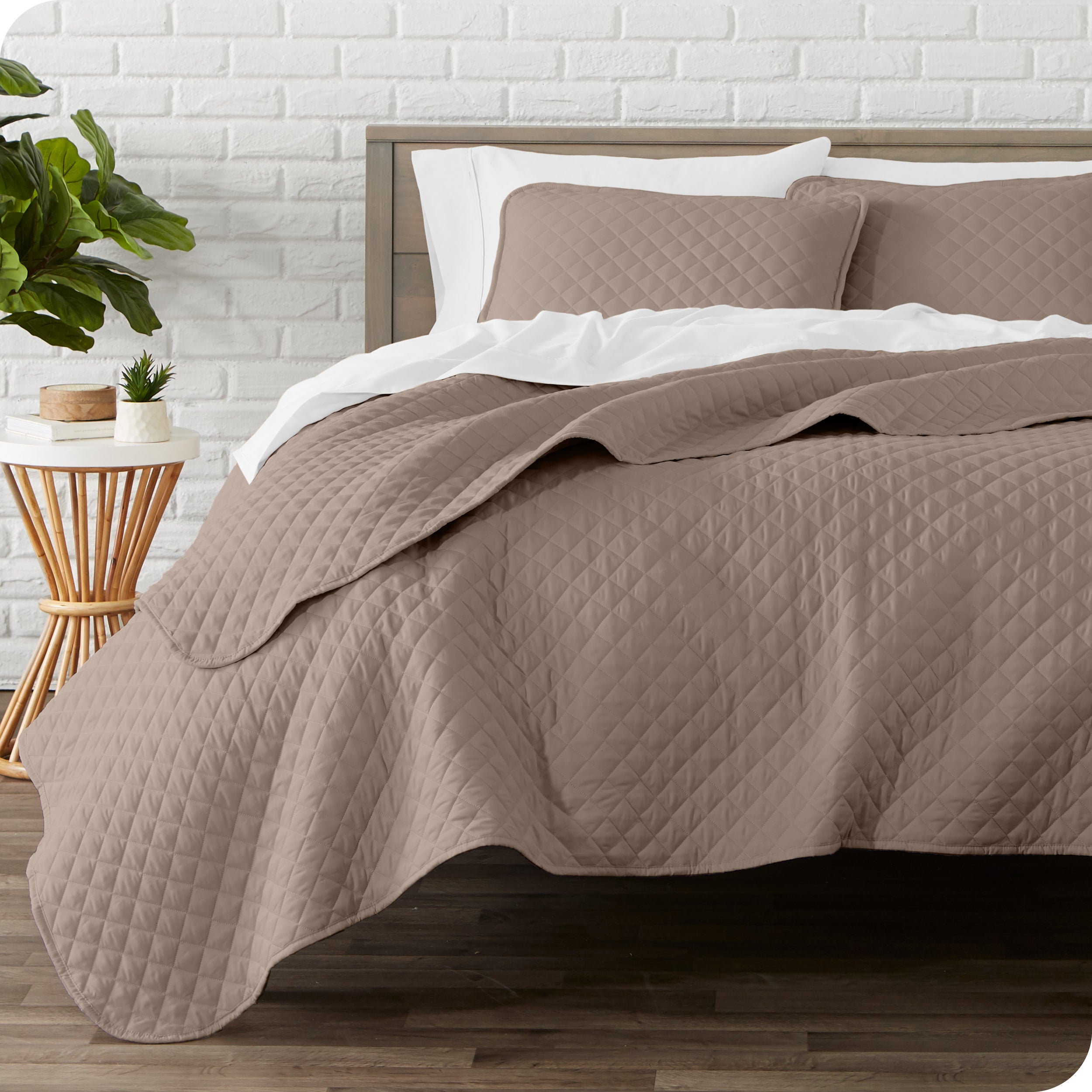 A quilted coverlet set on a bed