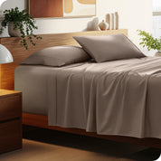 A cozy bedroom featuring a neatly made bed with soft, microfiber sheets