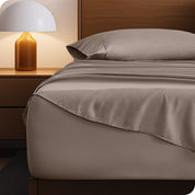 A cozy bedroom with a bed covered in soft microfiber sheets