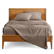 Microfiber sheet set on a bed with a wooden bed frame