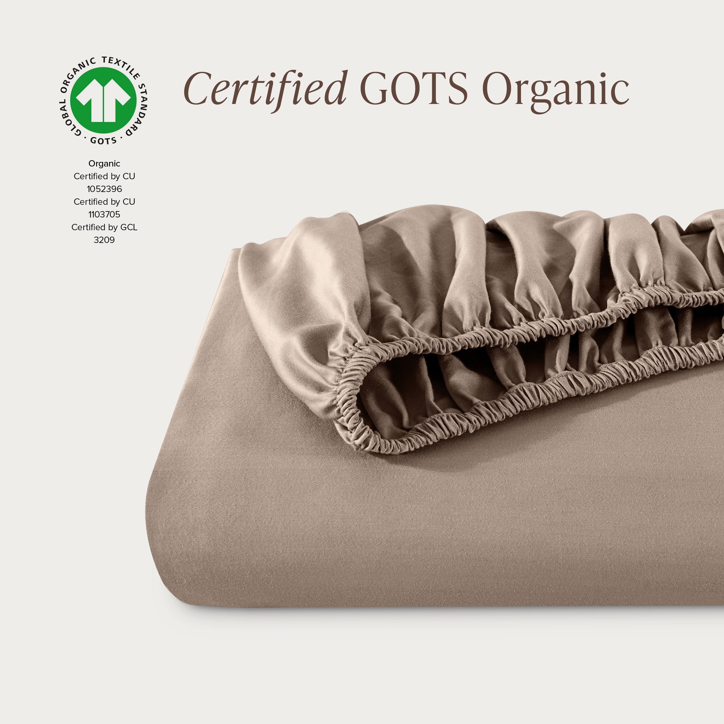 A single fitted sheet folded neatly showing part of the elastic. The fitted sheet is Certified GOTS Organic.