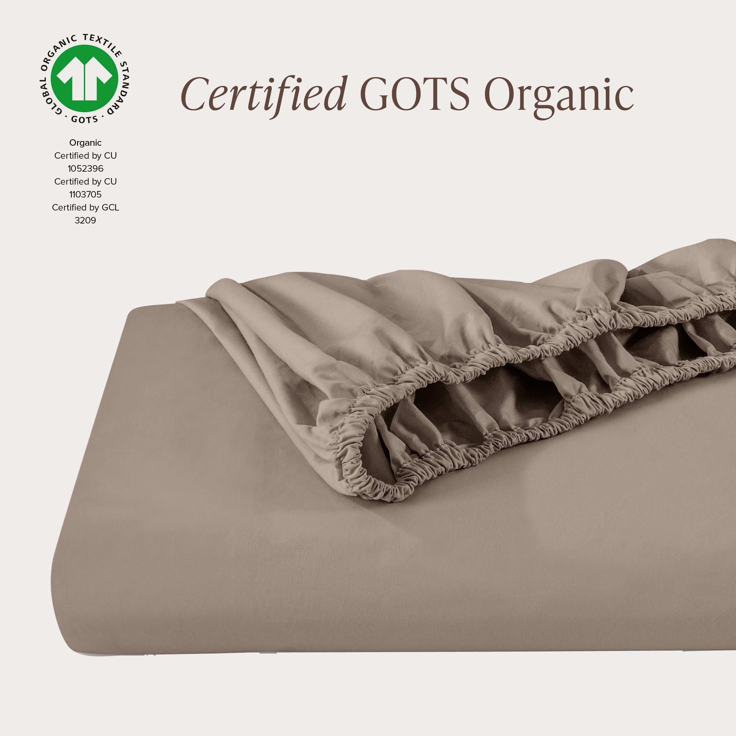 A single fitted sheet folded neatly showing part of the elastic. The fitted sheet is Certified GOTS Organic.