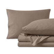Percale sheet set with two pillows and folded sheets on a white background