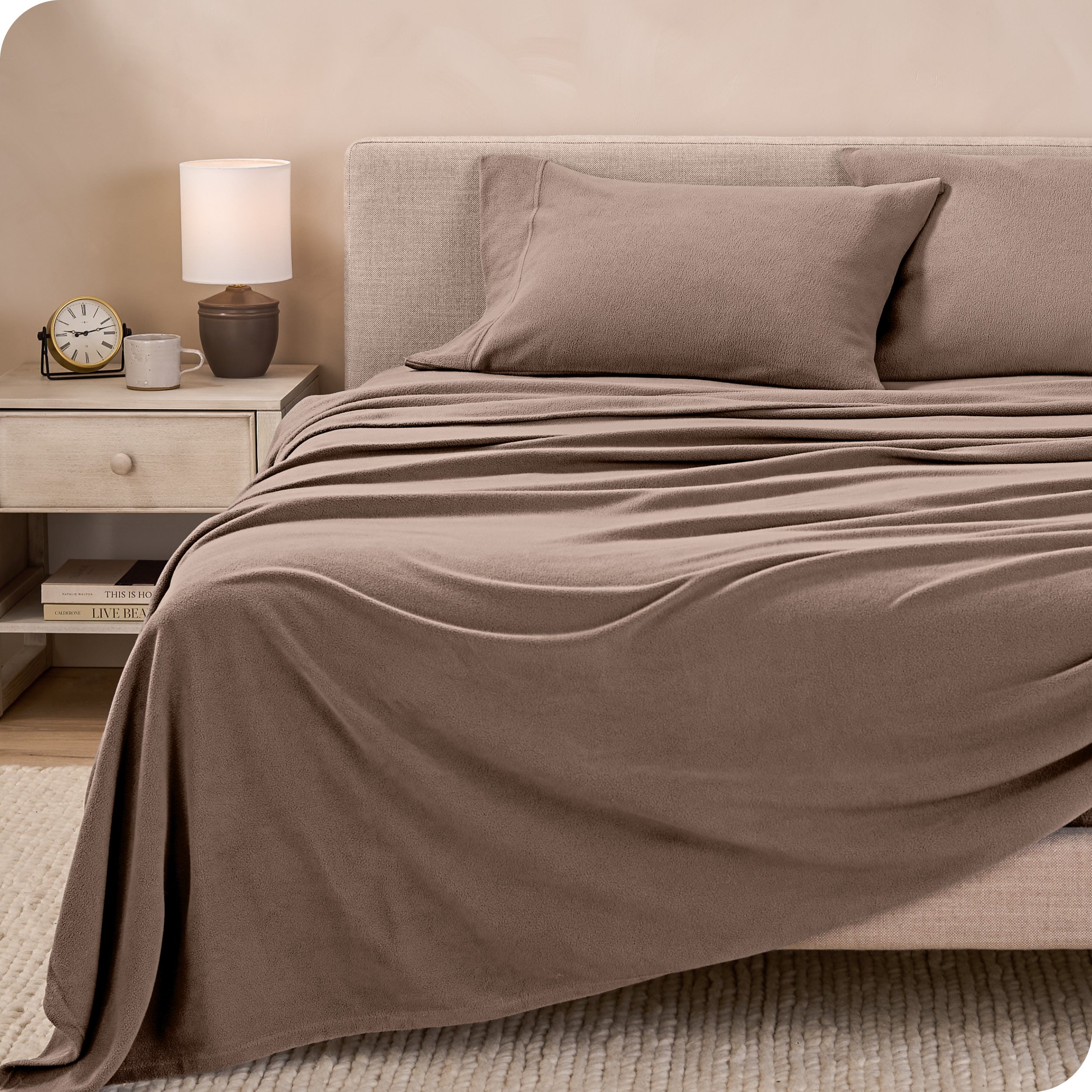 View of fleece sheets from the end of a bed with the top sheet draped over the side and end