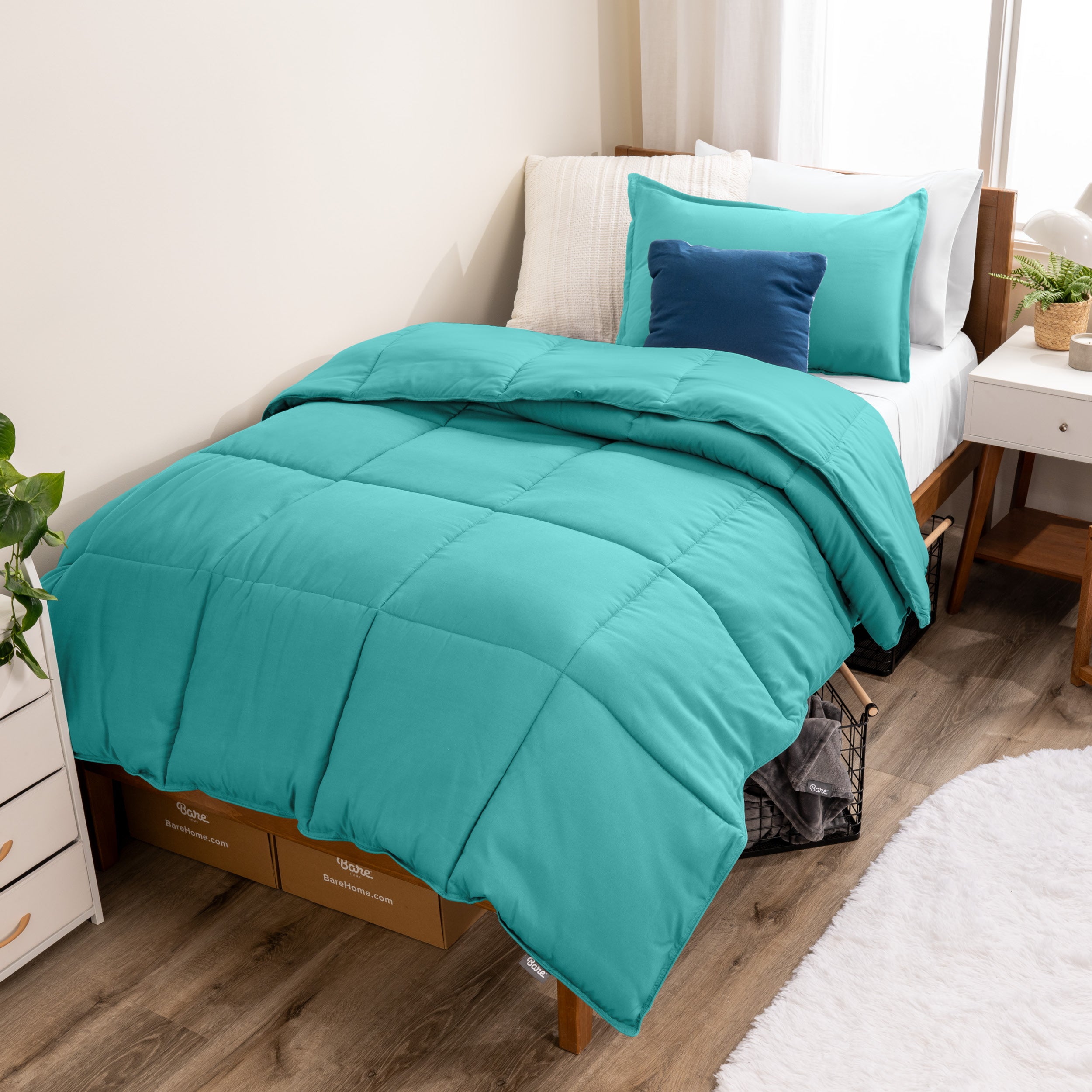 A modern bed with a down alternative comforter set on it