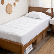 A mattress pad on a bed.