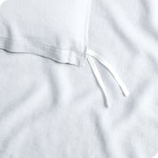 Close up of cloth tie straps for attaching duvet insert to inside of duvet cover