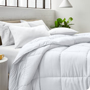 A bed made with pillows and a comforter