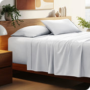 A cozy bedroom featuring a neatly made bed with soft, microfiber sheets