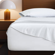 A cozy bedroom with a bed covered in soft microfiber sheets