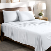 Stretch sheets on a bed with a wooden headboard in a bedroom setting.