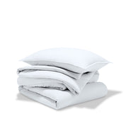 A comforter folded with a matching pillow sham stacked on top