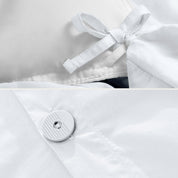 A close view of the corner tie of the duvet cover and the buttons for pillow shams