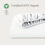 A single fitted sheet folded neatly showing part of the elastic. The fitted sheet is Certified GOTS Organic.