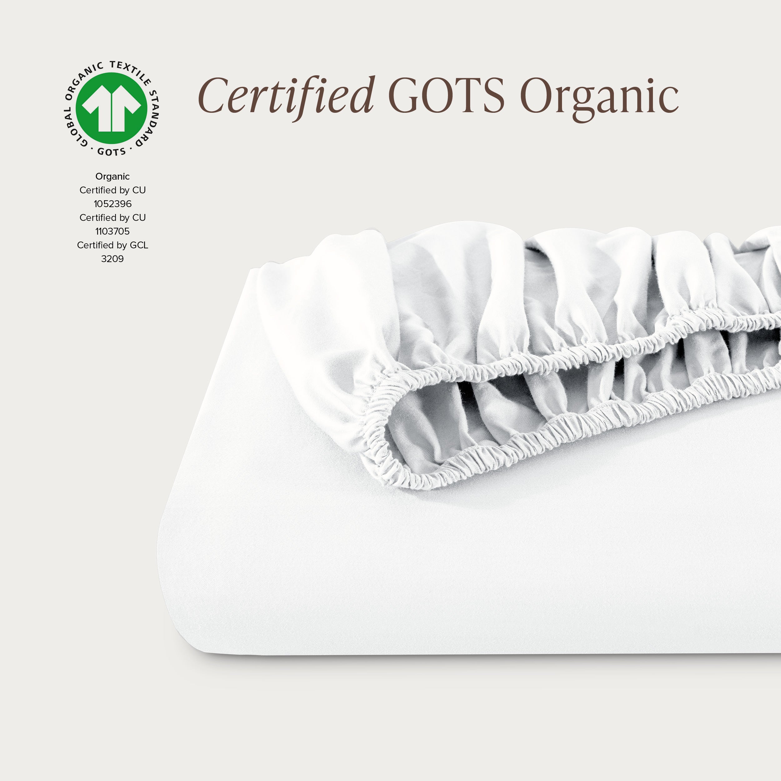 A single fitted sheet folded neatly showing part of the elastic. The fitted sheet is Certified GOTS Organic.