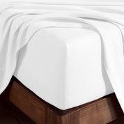 A corner of bed with fitted sheet to show the deep pocket feature and the texture.