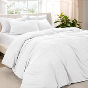Angled view of bed with a duvet cover folded over on itself