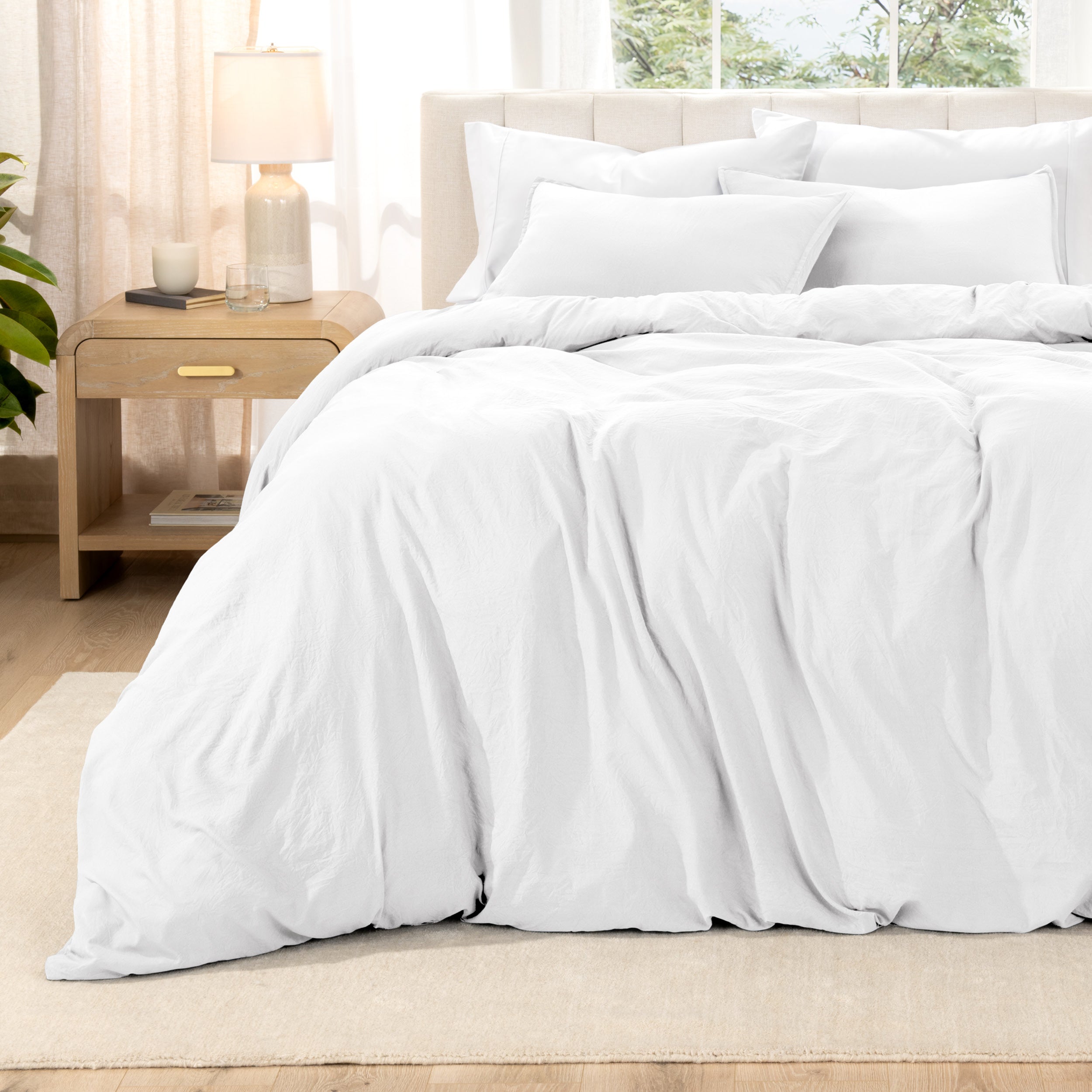Relaxing room scene with a duvet cover laid out over the bed