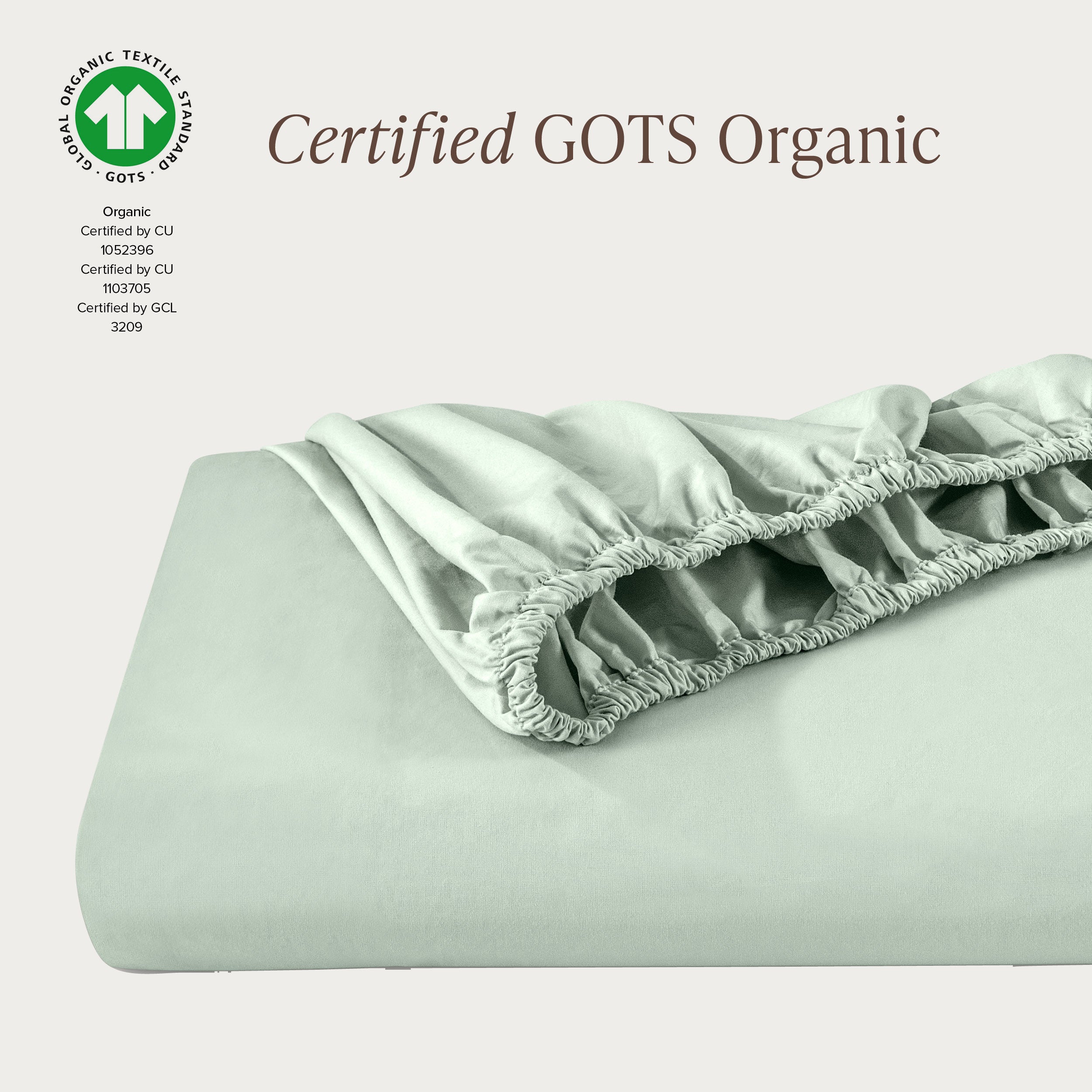 A single fitted sheet folded neatly showing part of the elastic. The fitted sheet is Certified GOTS Organic.