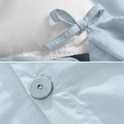 A close view of the corner tie of the duvet cover and the buttons for pillow shams