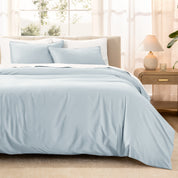 Warm bright room scene showing Sateen Duvet Set  laid out over the bed