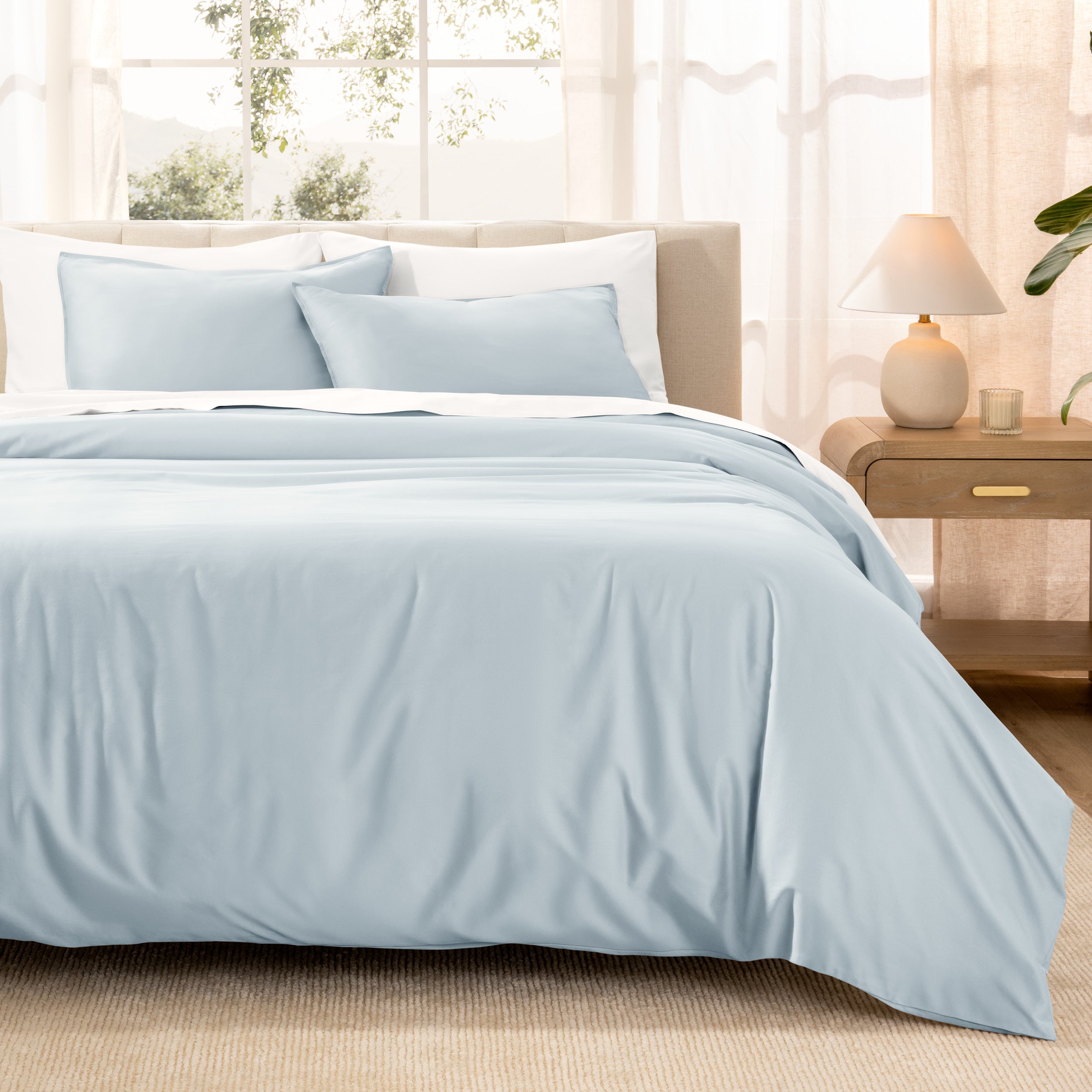 Warm bright room scene showing Sateen Duvet Set  laid out over the bed